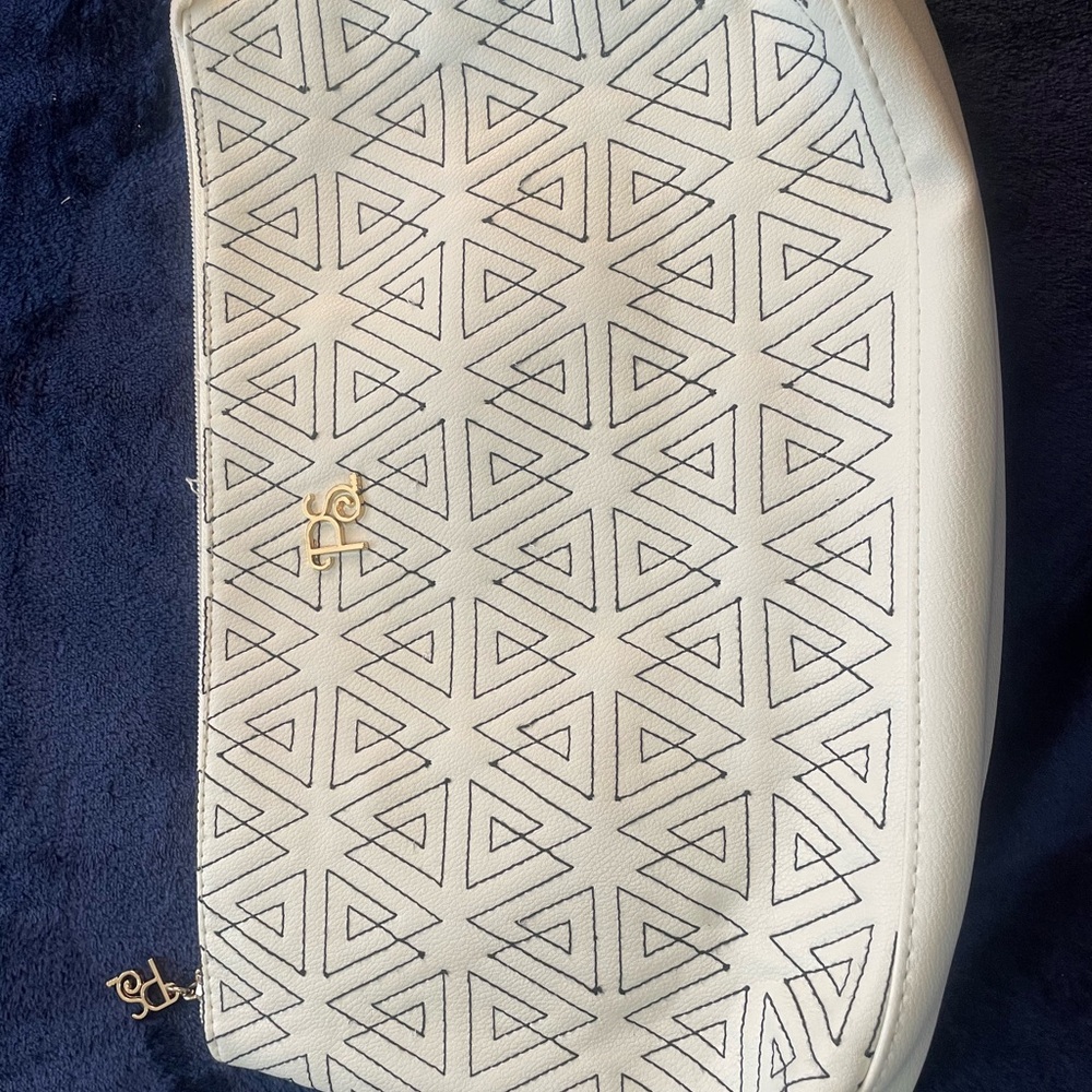 white faux leather wristlet bag cosmetic case fret work clutch